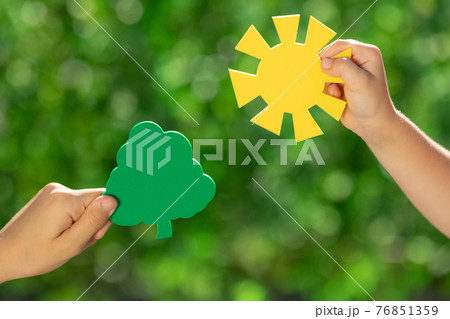 Children holding young green plant in hands 76851359