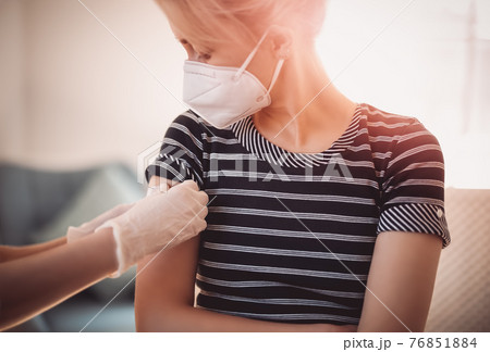 Woman and a doctor in the hospital after vaccination against Covid 19. 76851884