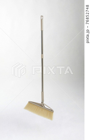 new broom with metal handle isolated on white new broom with metal handle isolated on white 76852748