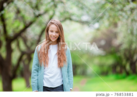 Little smiling girl playing in the park Little smiling girl playing in the park 76853881
