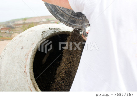 Laborer working with concrete 76857267