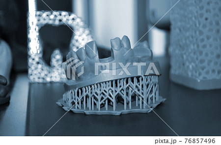 White prototype of the human foot skeleton printed on 3d printer on dark surface White prototype of the human foot skeleton printed on 3d printer on dark surface 76857496