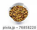 Almonds inside a porcelain bowl. Perfect shot for breakfast, vegan living and wellness. 76858220