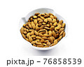 A group of shelled almonds in a white bowl. Perfect shot for breakfast, vegan, health and wellness. 76858539