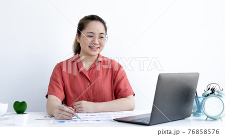Asian business woman in a bright t-shirt is working at home, Stay home, New normal, Covid-19 coronavirus, Social distancing, Coming up with ideas for work, Writing information in a notebook. Asian business woman in a bright t-shirt is working at home, Stay home, New normal, Covid-19 coronavirus, Social distancing, Coming up with ideas for work, Writing information in a notebook. 76858576