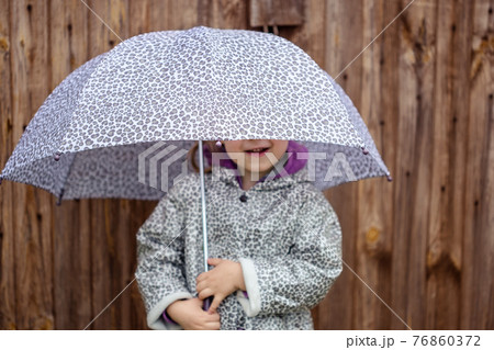 summer walk in the rain little girl with an umbrella 76860372