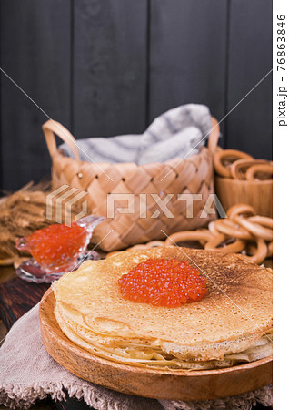 Shrovetide Maslenitsa Week festival meal. Stack of russian pancakes with red caviar. Rustic style 76863846