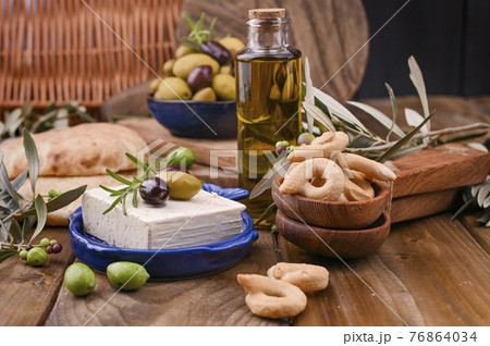 Greek cheese with olives and italian and ITALIAN CRACKERS or TARALLI . Fresh olive branches, olive 76864034