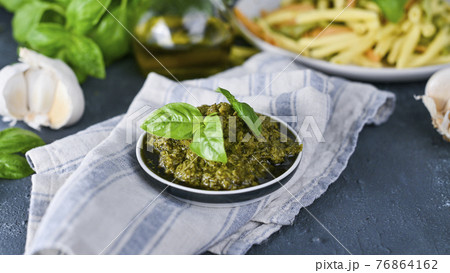Traditional italian pesto sauce in a plate on a black table. For fusilini pasta. Vegetarian food 76864162