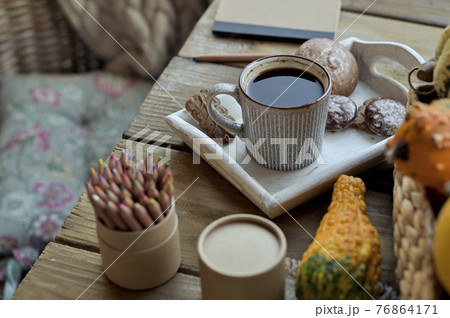 Autumn, pumpkins, hot steaming cup of coffee on a wooden table background. Seasonal, morning coffee 76864171