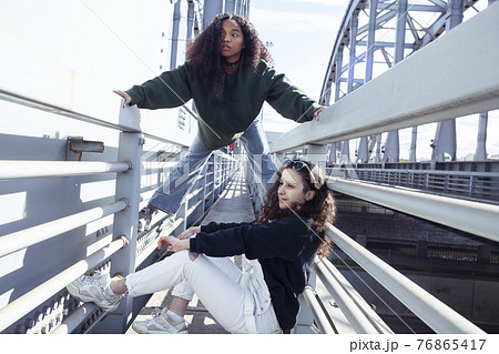 young cute teenage girls together in industrial zone happy smiling having fun, big city lifestyle fashion people young cute teenage girls together in industrial zone happy smiling having fun, big city lifestyle fashion people 76865417