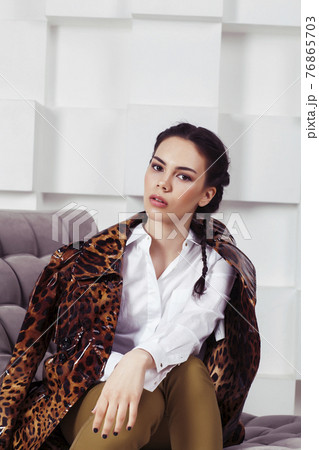 pretty stylish woman in fashion dress with in luxury rich room interior, lifestyle people concept, modern brunette 76865703