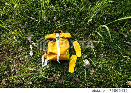 Summer vacation Yellow bag in summer meadow Summer vacation Yellow bag in summer meadow 76866452