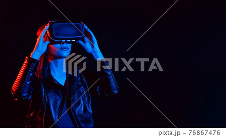 Girl wearing virtual reality glasses. Concept of future futuristic augmented reality technologies 76867476