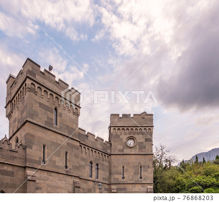 The walls and towers of the old palace on the background of a cloudy sky The walls and towers of the old palace on the background of a cloudy sky 76868203
