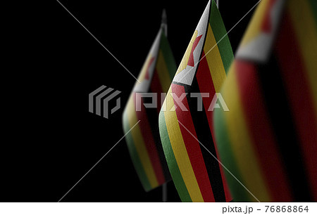 Small national flags of the Zimbabwe on a black background Small national flags of the Zimbabwe on a black background 76868864