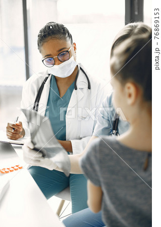Doctor examines a little girl in hospital Doctor examines a little girl in hospital 76869153