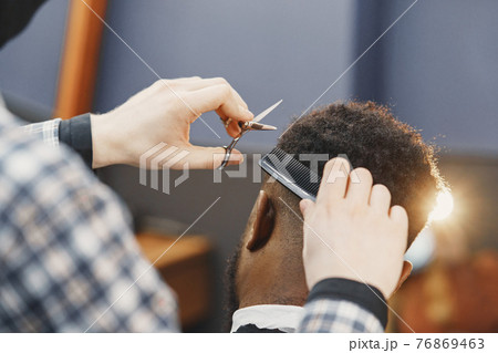 Young African-american man visiting barbershop 76869463