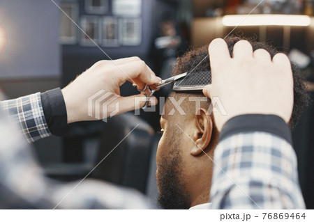 Young African-american man visiting barbershop 76869464