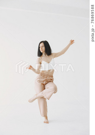 Beautiful young woman dancing in studio Beautiful young woman dancing in studio 76869588