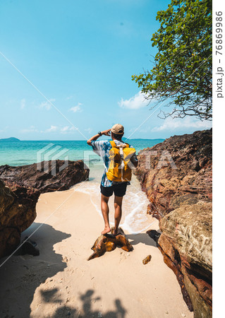 Seaside travel man with yellow bags travel to the beach Seaside travel man with yellow bags travel to the beach 76869986