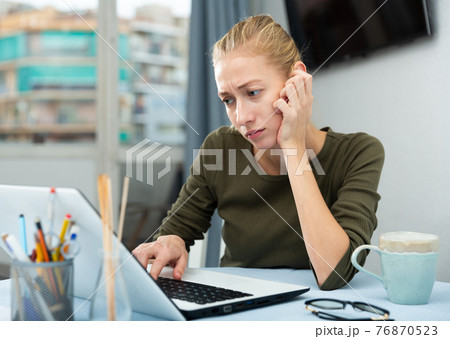 Tired woman working with laptop at the home Tired woman working with laptop at the home 76870523