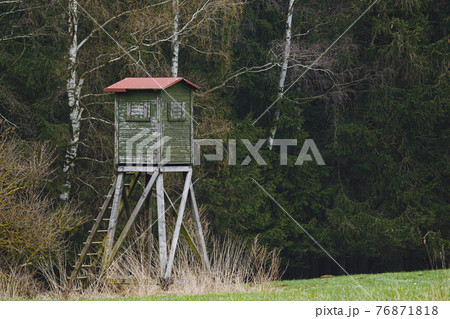 Wooden lookout tower for hunting in the woods and on meadow Wooden lookout tower for hunting in the woods and on meadow 76871818