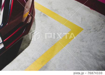 Yellow border lines of a parking in the petrol service station waiting for refuelling 76874330