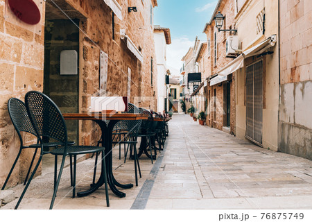 Empty tables of street cafe, Spain 76875749