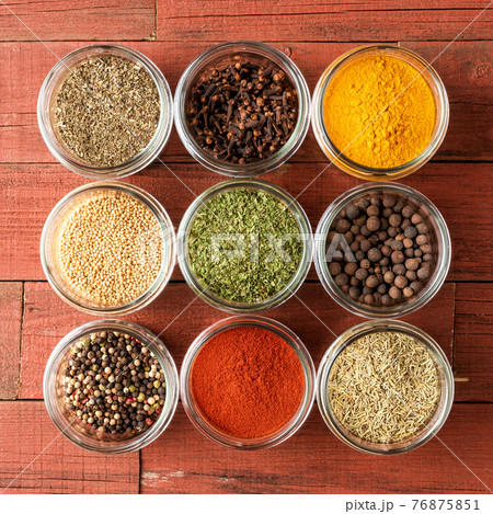 Colourful spices in bowls on wooden table. Big collection of spices. Top view 76875851