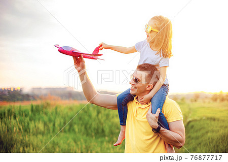 Happy father and daughter playing with plane 76877717