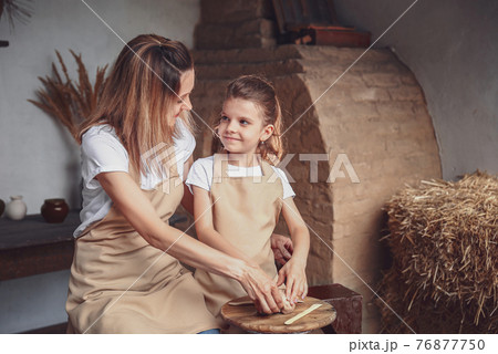 mother and daughter mold with clay, enjoying pottery art and pro mother and daughter mold with clay, enjoying pottery art and pro 76877750