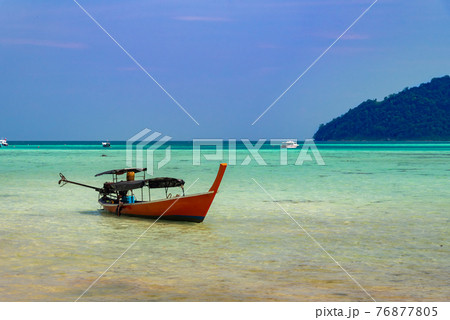 Thailand nature landscape. A long tail boat by the beach in Thailand 76877805