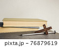 A cross with nail with bible over a light background.  76879619