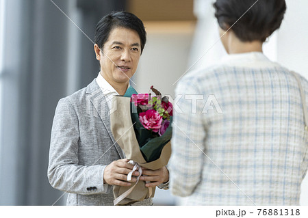 花束をプレゼントする男性　ミドルの夫婦　イメージ 76881318