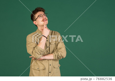 Caucasian man's portrait isolated over green studio background with copyspace Caucasian man's portrait isolated over green studio background with copyspace 76882536