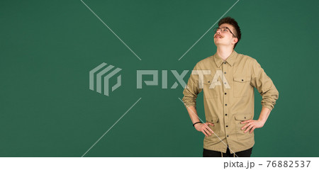 Caucasian man's portrait isolated over green studio background with copyspace Caucasian man's portrait isolated over green studio background with copyspace 76882537