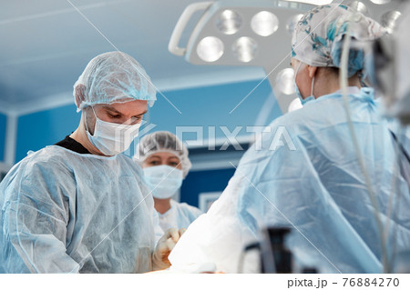 Team surgeon at work in operating room. Team surgeon at work in operating room. 76884270