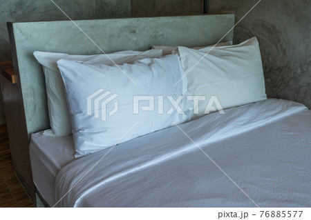 White pillows on a bed Comfortable soft pillows on the bed. 76885577