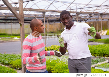 Communication between two gardeners during break between work 76885591