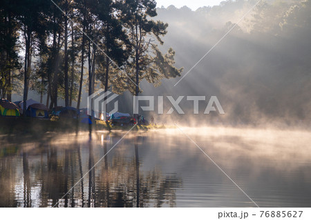 Fog or mist on river lake with forest trees in Pang Ung reservoir, Mae Hong Son, Thailand. Tourist attraction, surrounded by green pine, mountains, reflection from water. Fog or mist on river lake with forest trees in Pang Ung reservoir, Mae Hong Son, Thailand. Tourist attraction, surrounded by green pine, mountains, reflection from water. 76885627