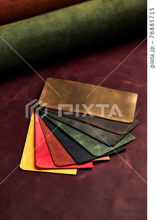 Artificial leather samples on a cow leather background. Top view. Artificial leather samples on a cow leather background. Top view. 76885715