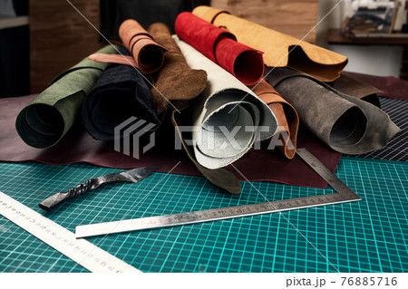 Artificial leather samples on a cow leather background. Top view. Artificial leather samples on a cow leather background. Top view. 76885716