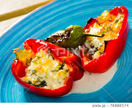 Appetizer sweet red peppers stuffed with soft cheese brynza 76886574