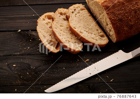 Homemade tartine bread on dark wooden table Homemade tartine bread on dark wooden table 76887643
