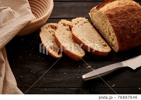 Homemade tartine bread on dark wooden table Homemade tartine bread on dark wooden table 76887646