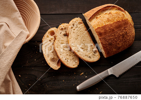 Homemade tartine bread on dark wooden table 76887650