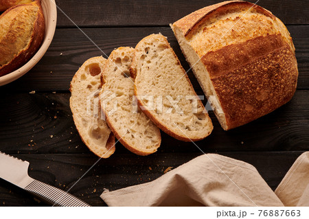 Homemade tartine bread on dark wooden table 76887663