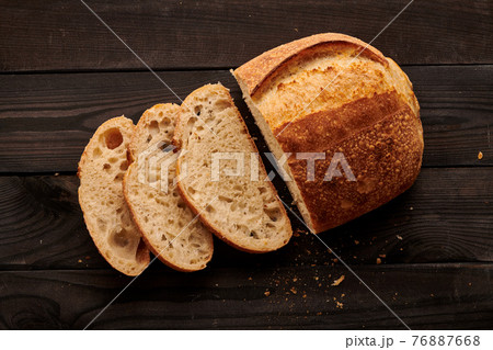 Homemade tartine bread on dark wooden table 76887668
