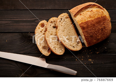 Homemade tartine bread on dark wooden table 76887669